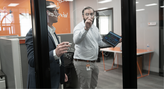 Concept team members collaborating at a whiteboard